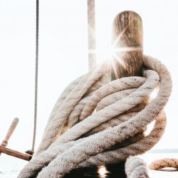 yacht rope tied up on a wooden cleat